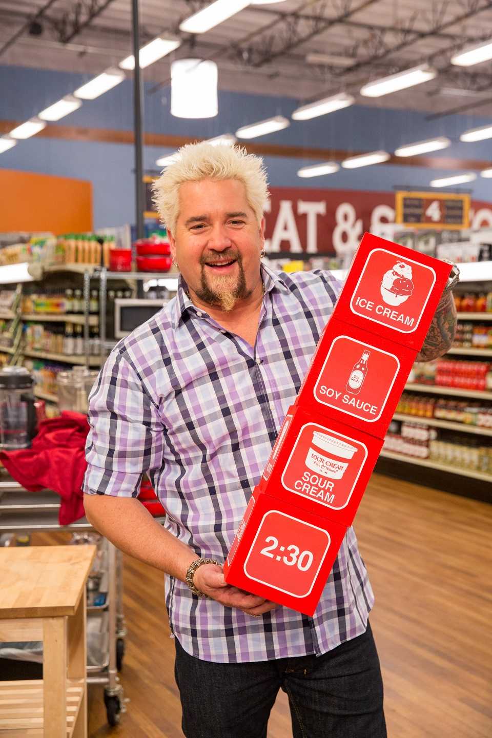 Host Guy Fieri with the dice for Game 1, Let It Roll,  as seen on Food Network's Guy's Grocery Games, Season 5.