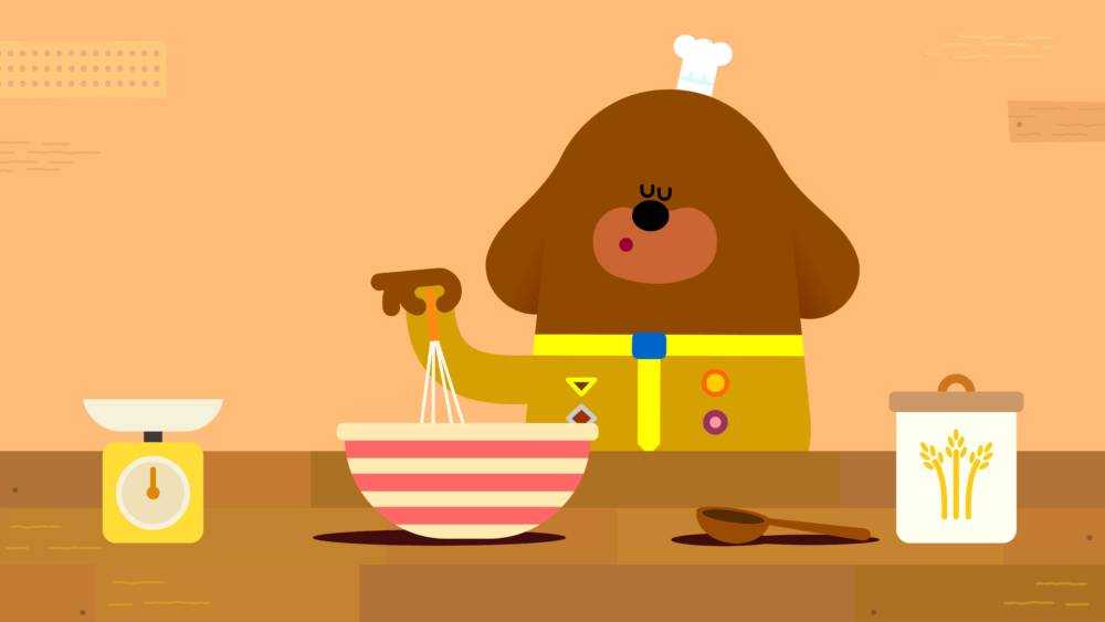 Duggee is happily whisking away