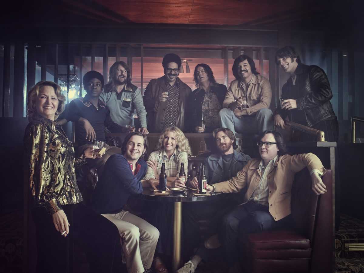 The cast of the Showtime original series I'M DYING UP HERE (Season 1, Gallery). - Photo: Patrick Ecclesine/SHOWTIME - Photo ID:  IDUH_S1_PRArt2.R

Pictured:  (Standing) Melissa Leo as Goldie, RJ Cyler as Adam, Stephen Guarino as Sully, Erik Griffin as Ralph, Jon Daly as Arnie, Al Madrigal as Edgar and Jake Lacy as Nick; (seated) Michael Angarano as Eddie, Ari Graynor as Cassie, Andrew Santino as Bill and Clark Duke as Ron.
