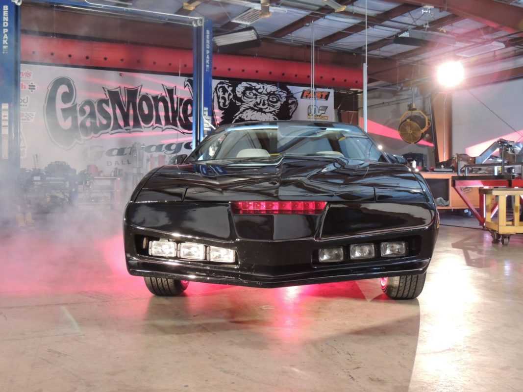 The restored 1985 Pontiac Trans Am KITT Car glows above an electrifying red light.