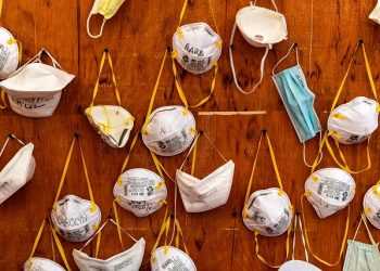 TOPSHOT - Protective masks bearing the names of medical staffers and nurses are pictured pinned to a wall on April 2, 2020 at the operative field hospital for coronavirus patients, financed by US evangelical Christian disaster relief NGO Samaritans Purse, outside the Cremona hospital, Lombardy. - Fully operational, the structure consist of 15 tents, 60 beds, 8 of which in intensive care. (Photo by MIGUEL MEDINA / AFP) (Photo by MIGUEL MEDINA/AFP via Getty Images)