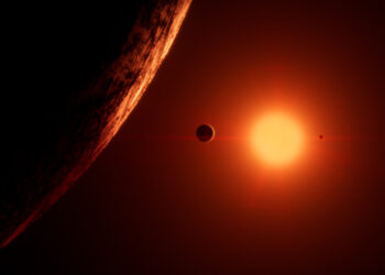 Picture Shows: Trappist – 1 is a red dwarf star. Just 10% the mass of the Sun, and 1% as bright, it’s red light dimly lights its seven earth-size planets.