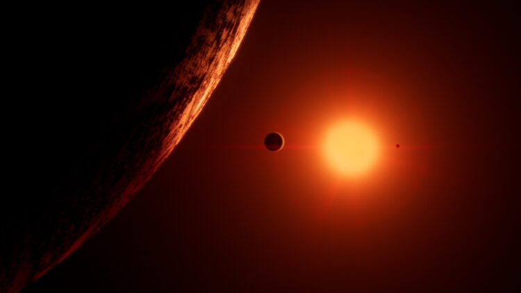 Picture Shows: Trappist – 1 is a red dwarf star. Just 10% the mass of the Sun, and 1% as bright, it’s red light dimly lights its seven earth-size planets.